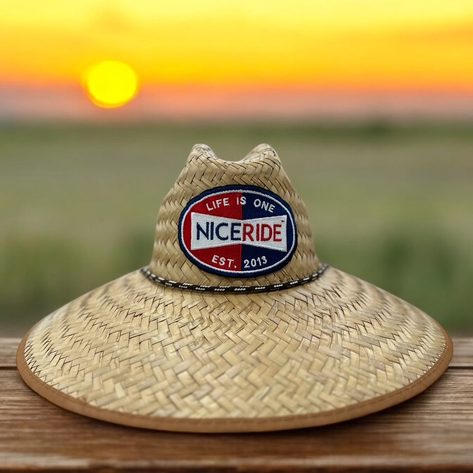 NICERIDE Champion Straw Sun Hat with logo, perfect for beach sun protection at sunset.