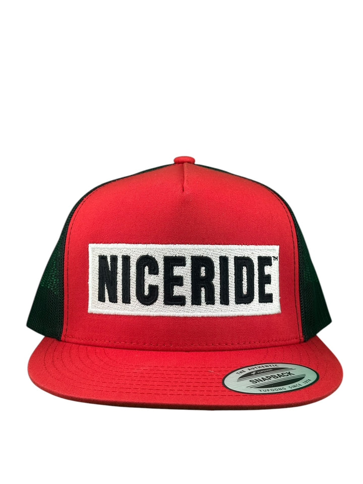 Unisex adjustable red trucker hat with NICERIDE logo embroidered on front and green mesh back.