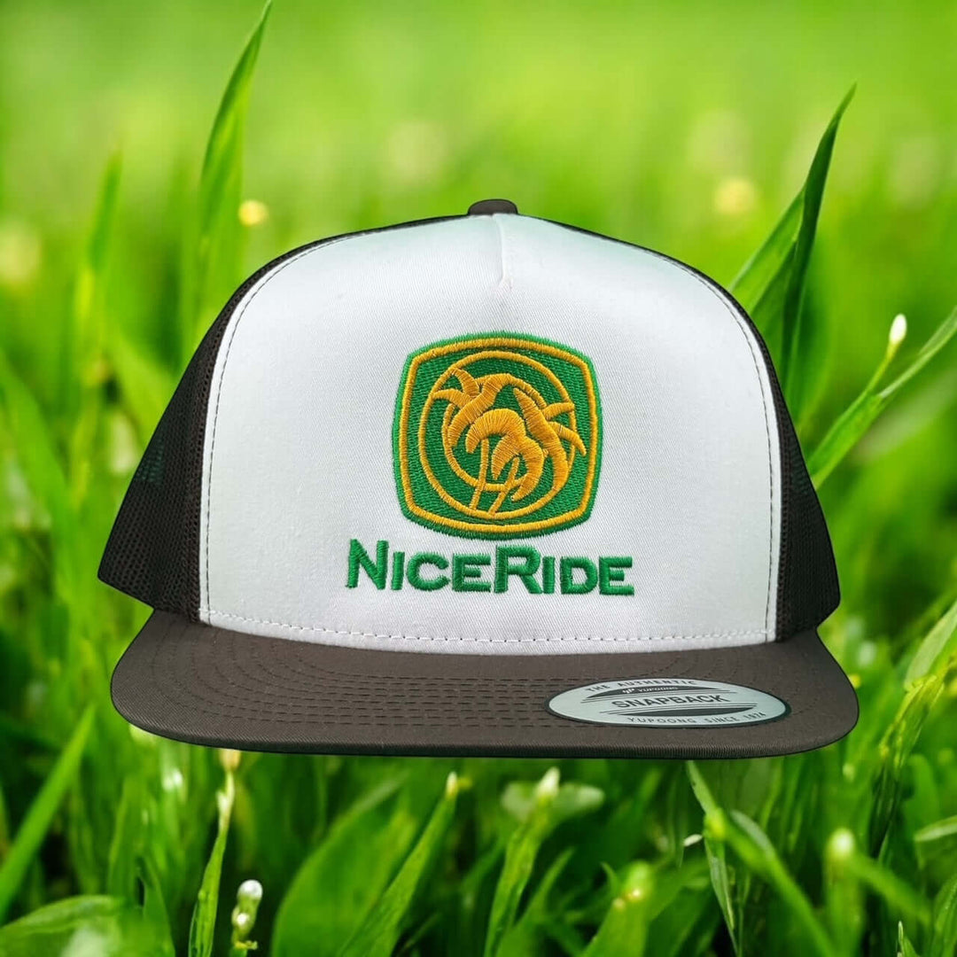 NICERIDE Moe-Doe unisex trucker hat with embroidered logo on grassy background.