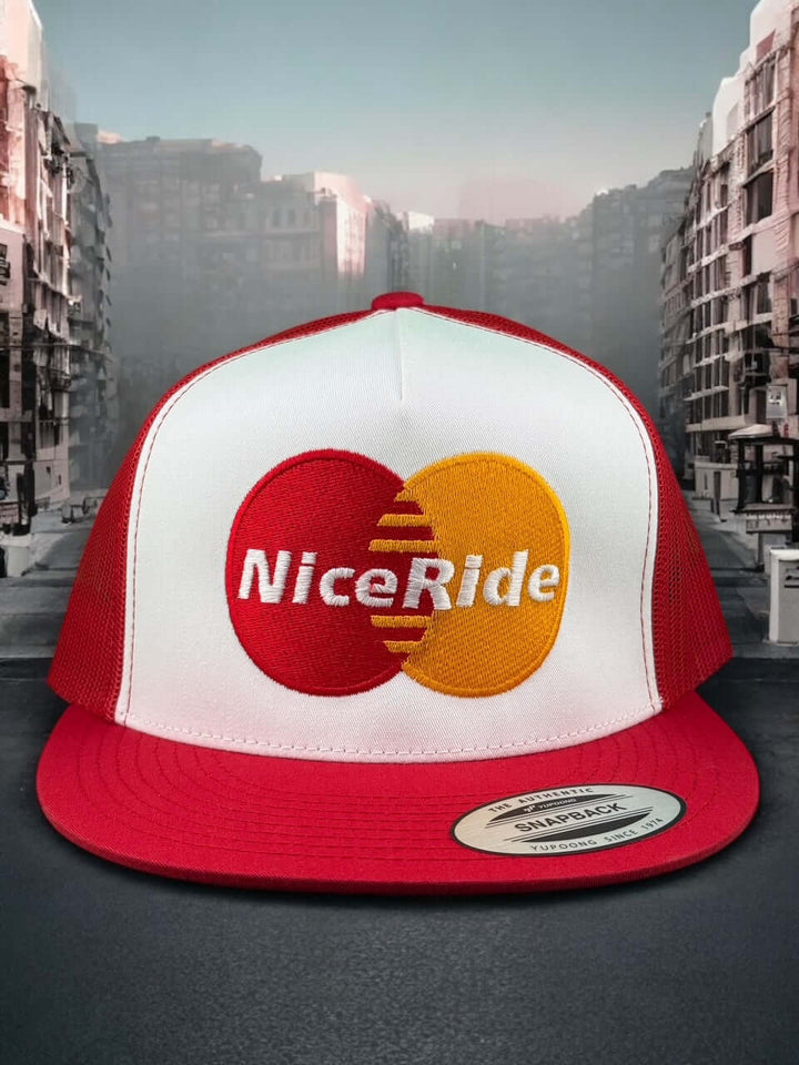 NICERIDE unisex adjustable trucker hat with red and white colors featuring embroidered logo in a cityscape background.