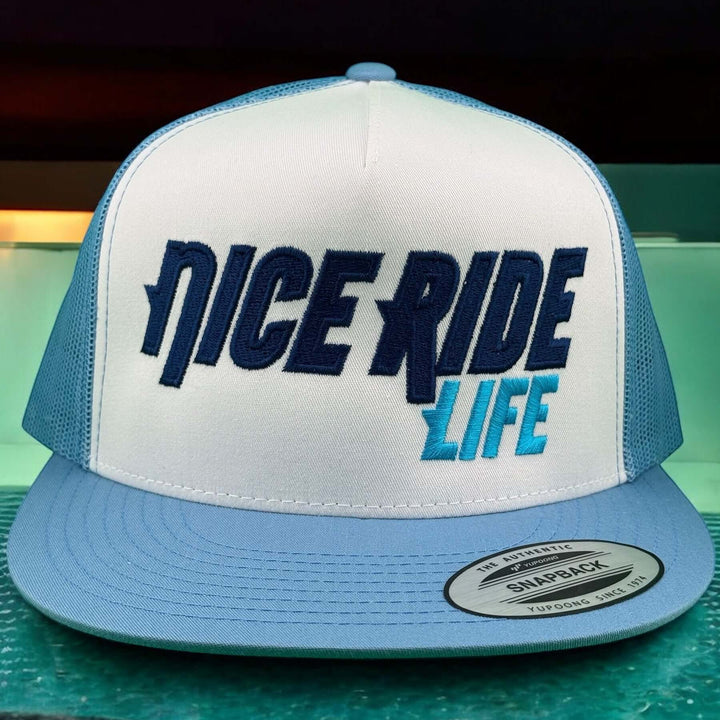 NICERIDE Life Trucker Hat in blue and white with bold logo on classic snapback design.