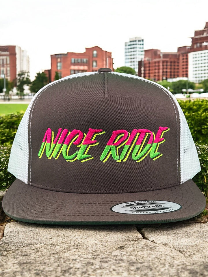Slump Buster unisex adjustable trucker hat featuring colorful "NICERIDE" logo on a gray background.