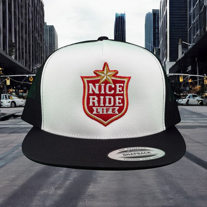 NICERIDE Dallas Unisex Trucker Hat in urban setting, featuring red logo on white and black snapback design.