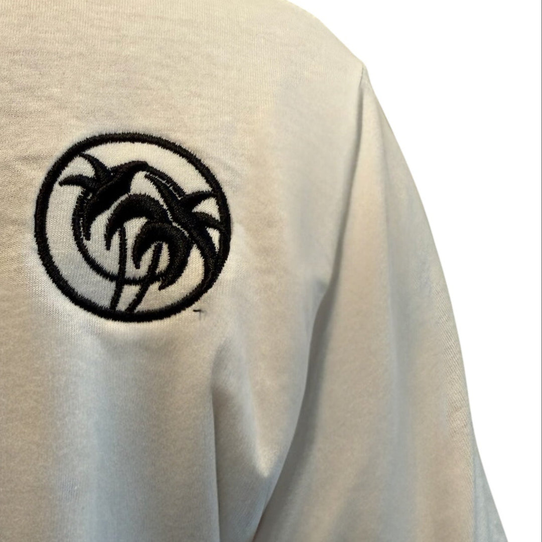 Close-up of NICERIDE ‘TRI’ Palm design embroidered on a white cotton men&