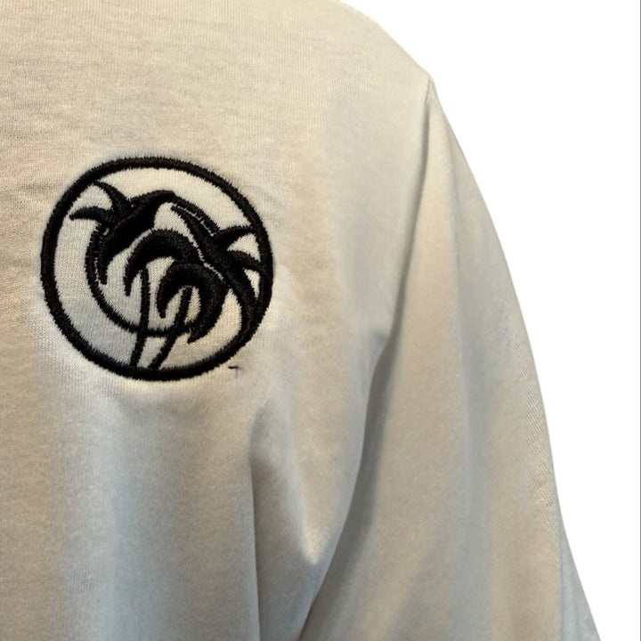 Close-up of NICERIDE ‘TRI’ Palm design embroidered on a white cotton men&