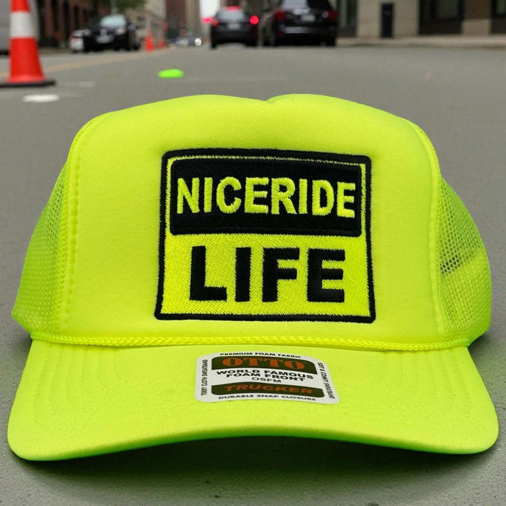 NICERIDE "Caution" Otto Unisex Foam Trucker Hat with embroidered logo on a vibrant yellow background.
