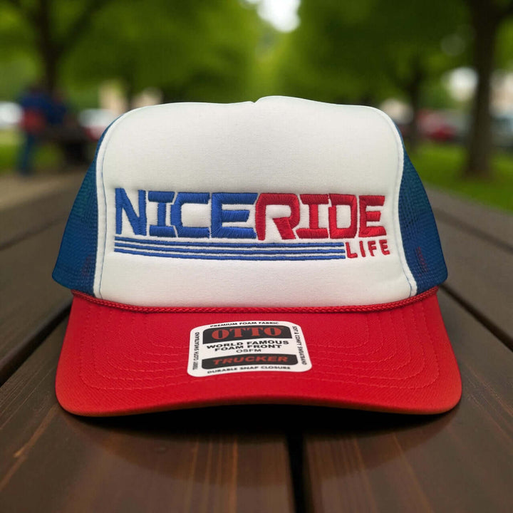 RedLine foam trucker hat featuring bold NICERIDE logo on structured front panel in red and blue.