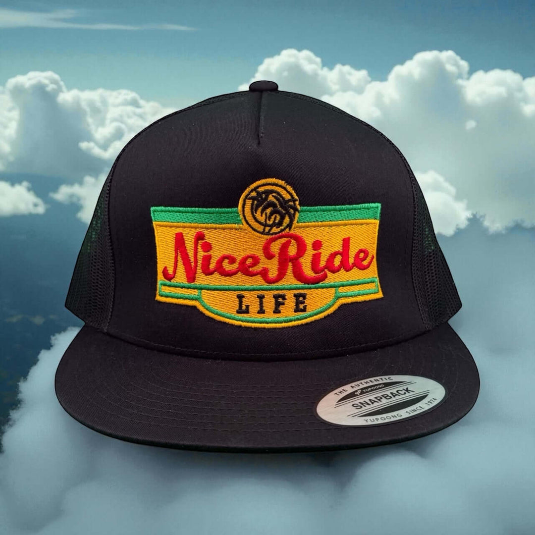 Niceride “Bubble Water” 6006 unisex snapback trucker hat with vibrant logo against a cloudy background.
