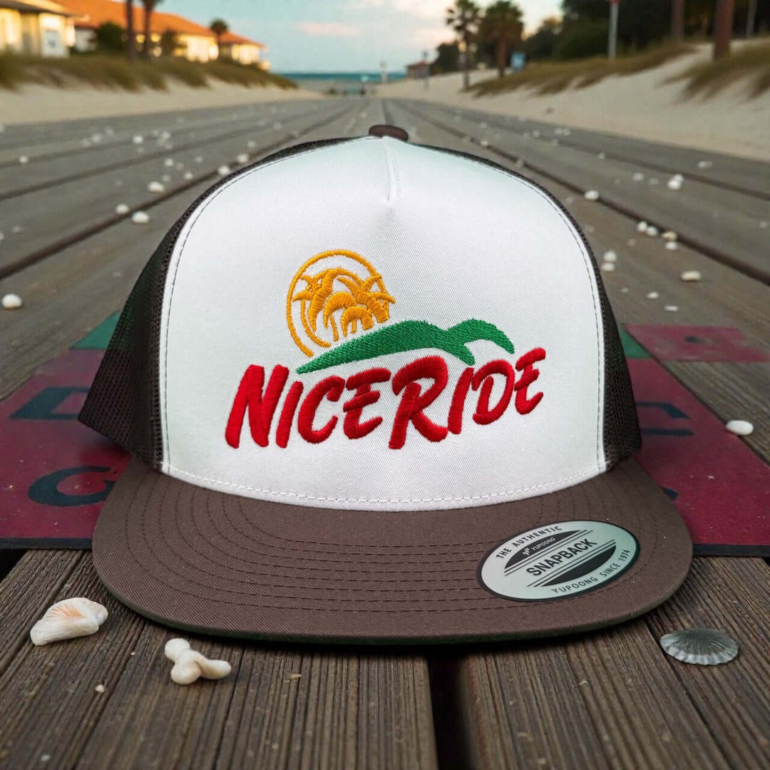Niceride Crinkle Cut 6006 Unisex Adjustable Trucker Hat with palm logo on wooden boardwalk backdrop
