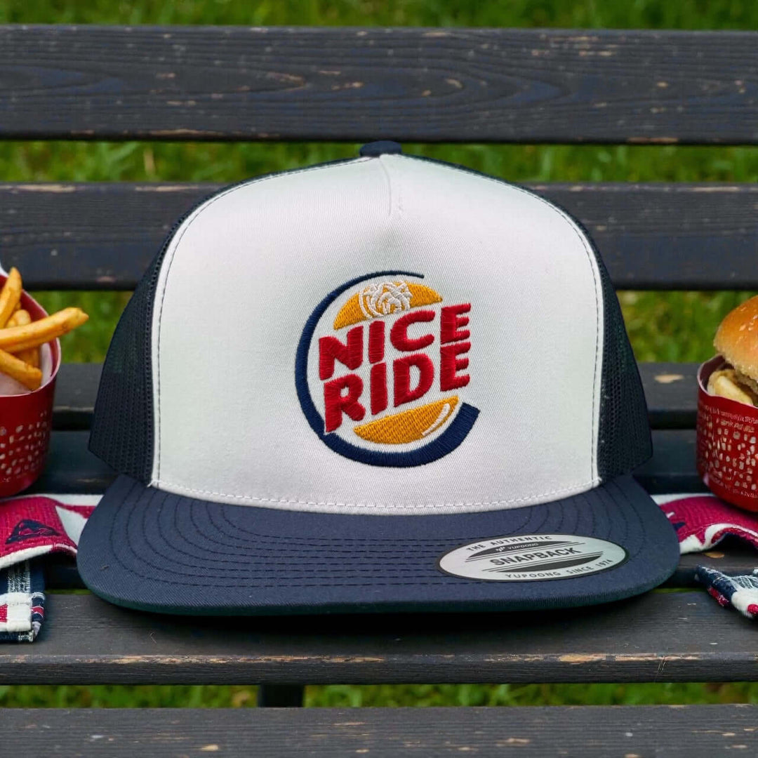 NICERIDE unisex adjustable trucker hat with logo on a picnic table, ideal casual hat for style and comfort.