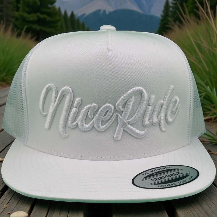 Signature 3D Puff unisex adjustable trucker hat with NiceRide embroidery in trendy white thread.