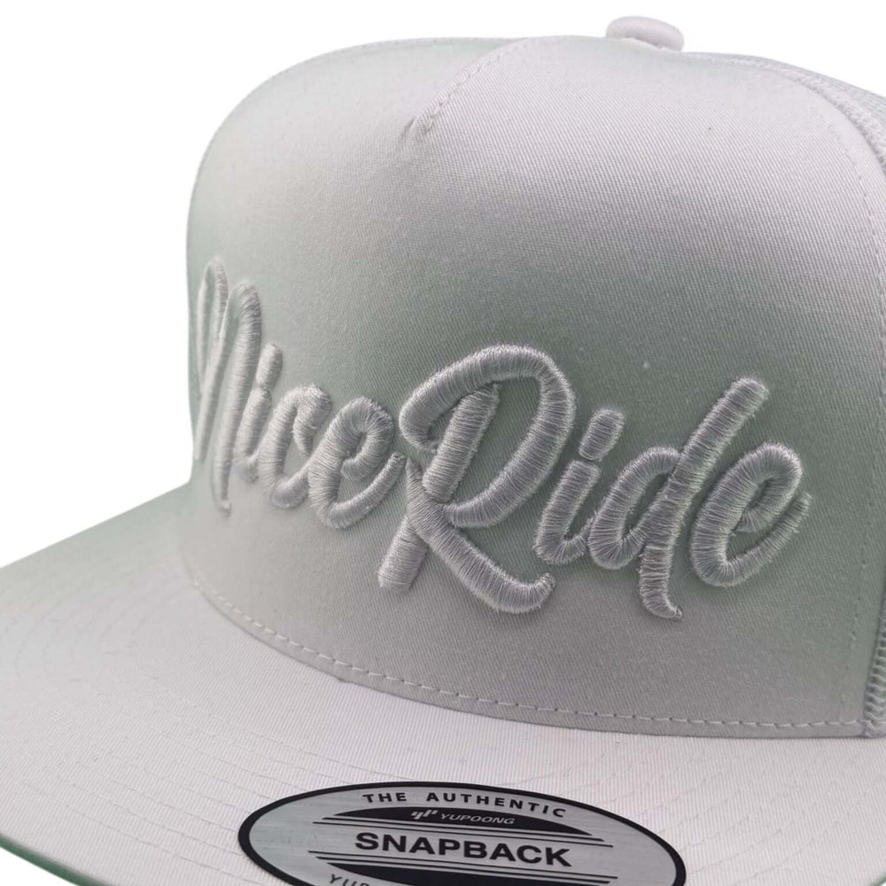 Close-up of NICERIDE's Signature 3D Puff unisex adjustable trucker hat with white raised embroidery.