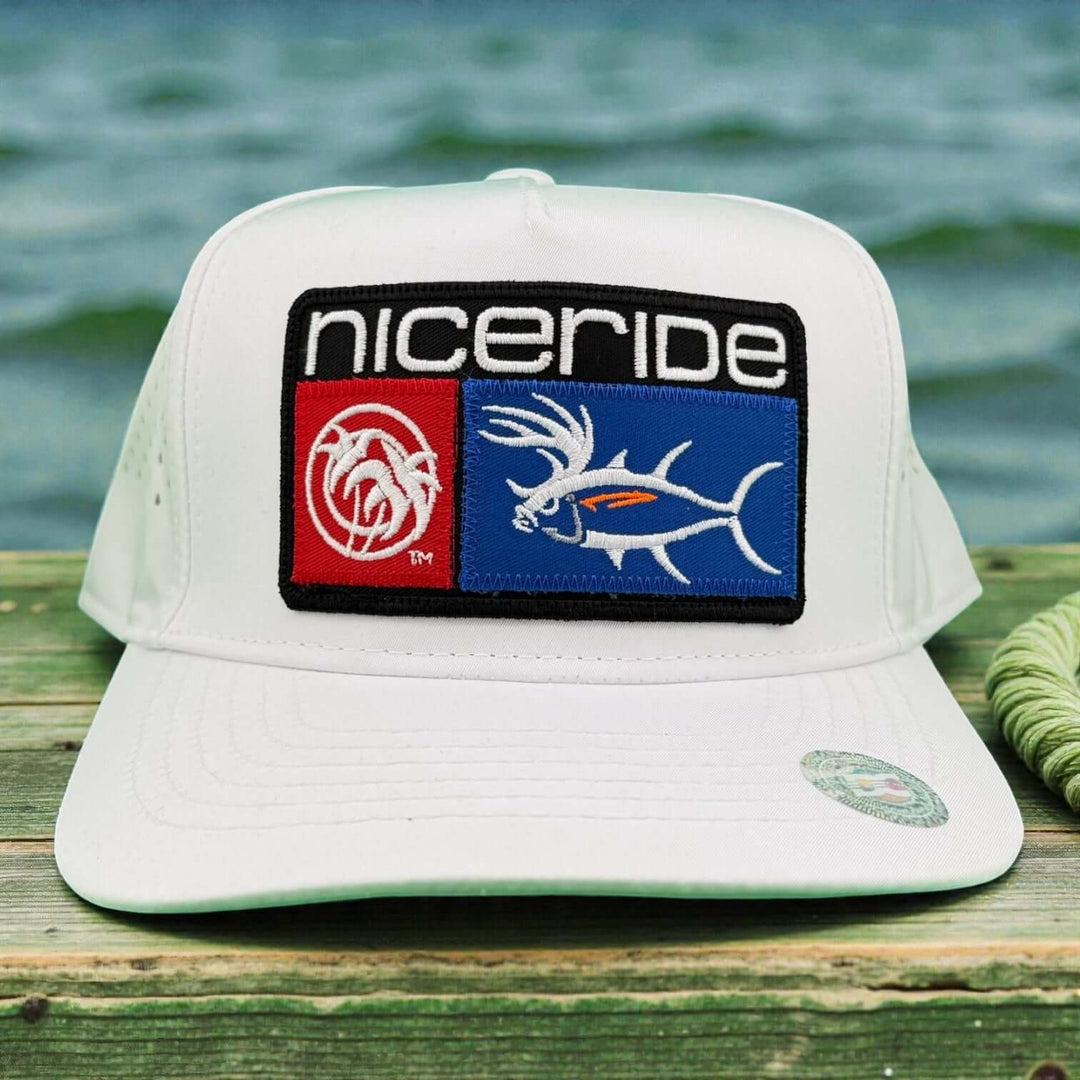 NICERIDE Buck-Eye Patch 5-Panel Performance Fishing Trucker Cap in white with embroidered logos on a wooden surface.