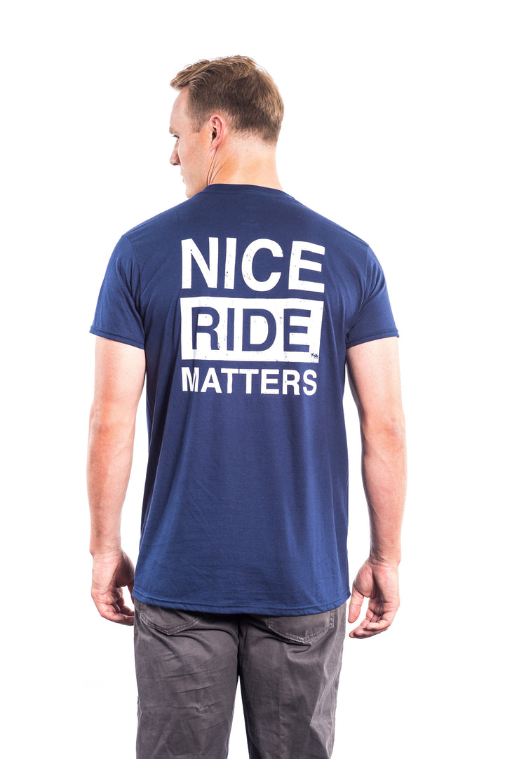 Back view of a man wearing a blue shirt with &