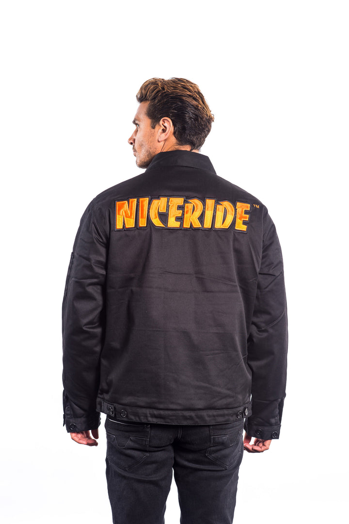 Man wearing a black canvas jacket with NICERIDE embroidered on the back and left chest.