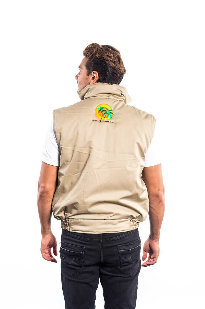 Man wearing a beige cargo vest featuring NICERIDE embroidery on the left chest and classic palm logo on the back.