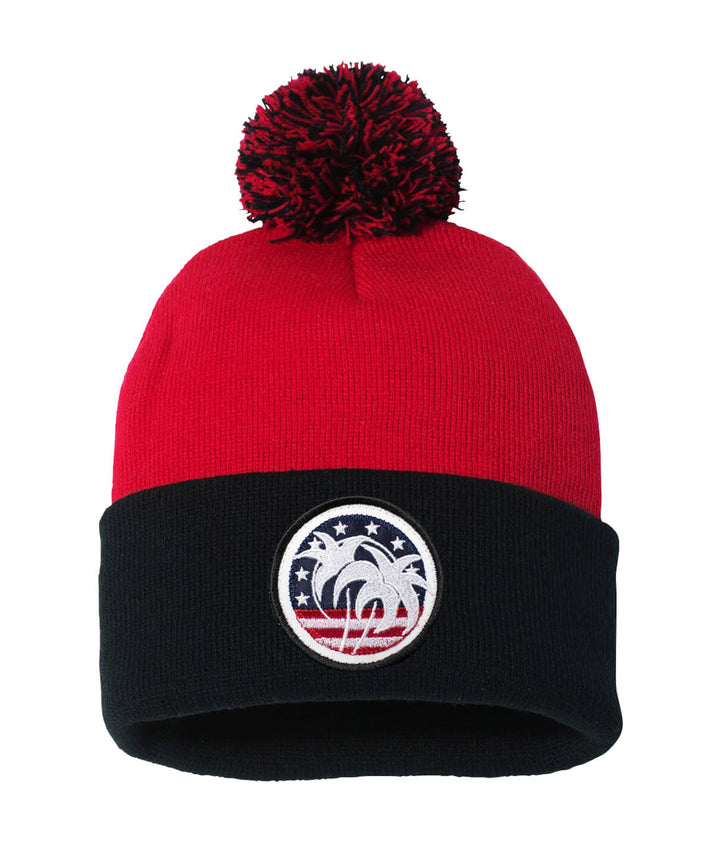 Spirit of 76 beanie featuring a red design with a pom-pom and embroidered palm tree logo.