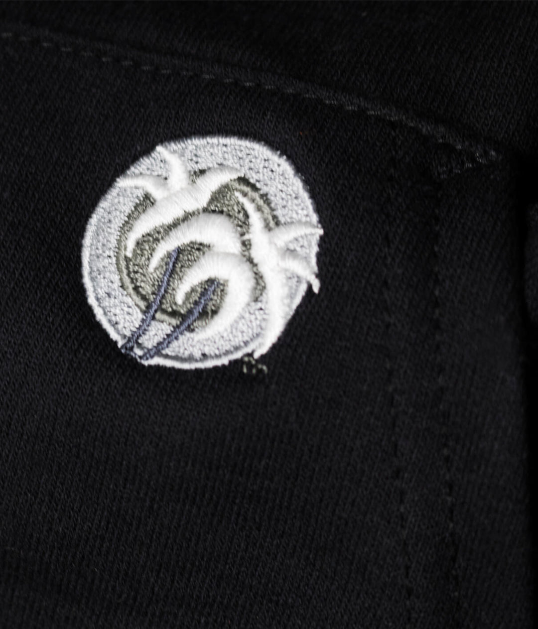 Close-up view of the NICERIDE classic palm logo embroidered on a black hoodie pocket.