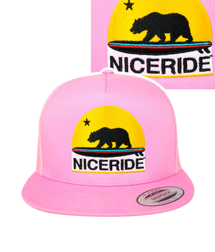 Pink NICERIDE trucker hat with detailed bear and sunset embroidery, perfect for outdoor adventures.