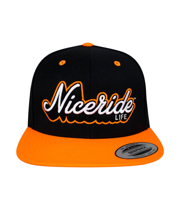 Half Pipe Flatbill Snapback Hat by NICERIDE with black and orange colors, featuring embroidered logo on front.
