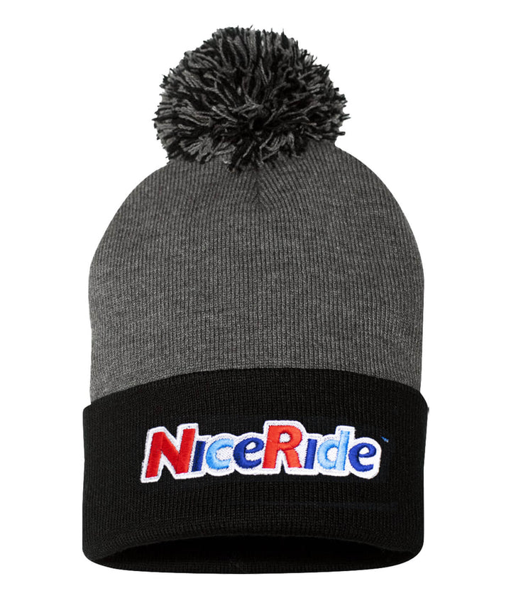 NICERIDE Smile Puff Beanie with pom-pom, featuring a black cuff and cheerful logo, perfect for warmth and style.