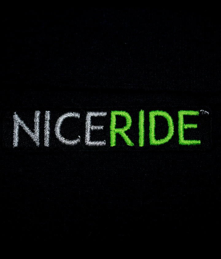 NICERIDE logo embroidered in white and green on a black background from a hoodie.