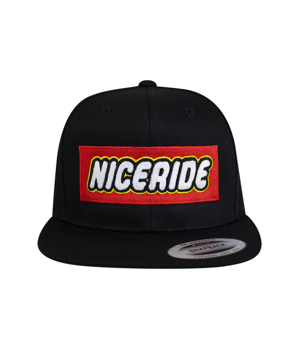 NICERIDE youth snapback hat with red embroidered logo on black front panel.