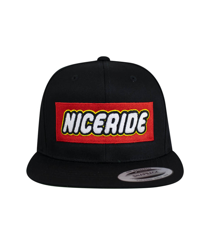 NICERIDE youth snapback hat with red embroidered logo on black front panel.