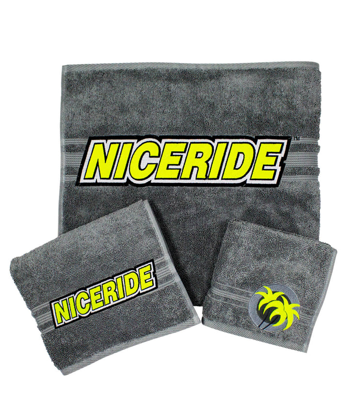Slick 3 Piece Towel Set in gray featuring NICERIDE logo on body towel, hand towel, and wash cloth.
