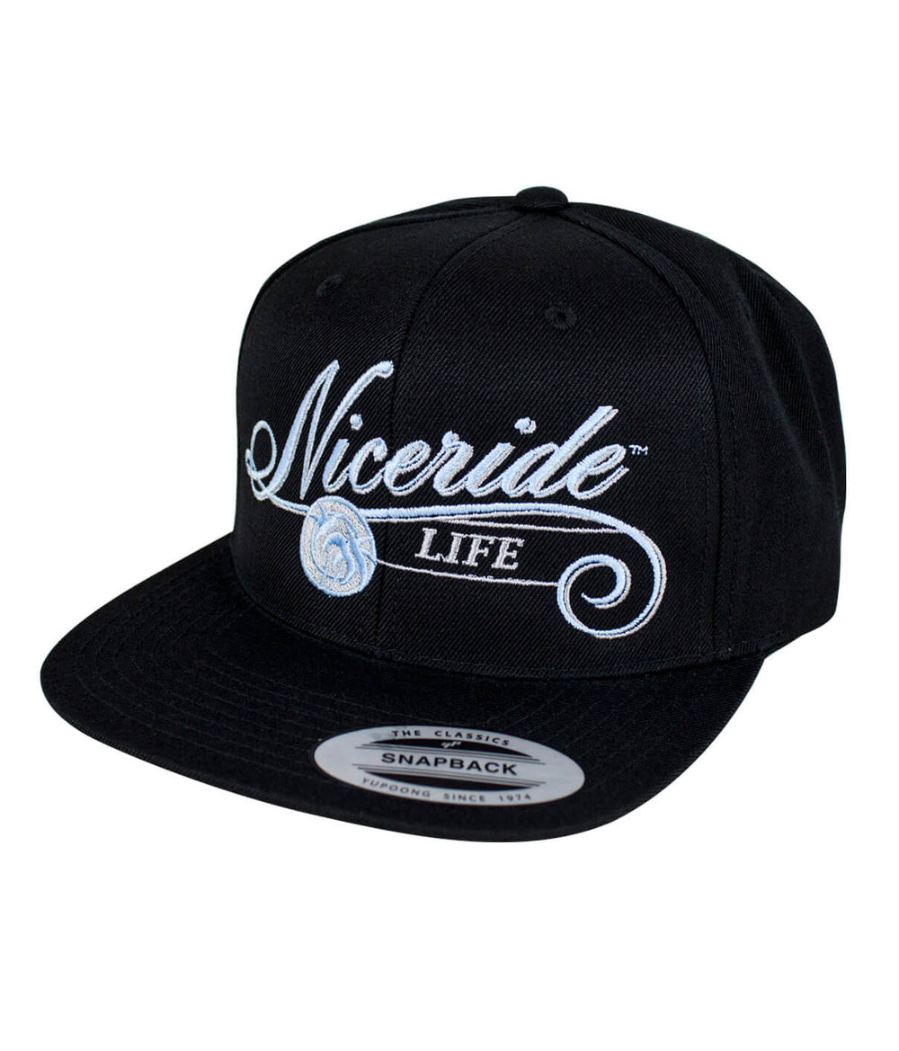 The Life snapback hat by NICERIDE featuring embroidered design and palm logo on a black baseball cap.
