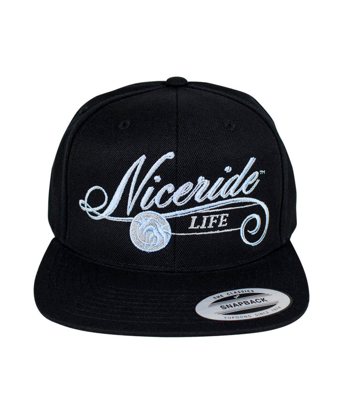The Life Snapback Hat by NICERIDE featuring embroidered design on black cap.