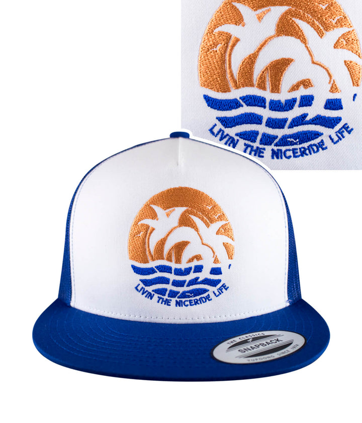 Pair-a-Dice hat featuring a colorful palm and sunset design, perfect for summer outings.