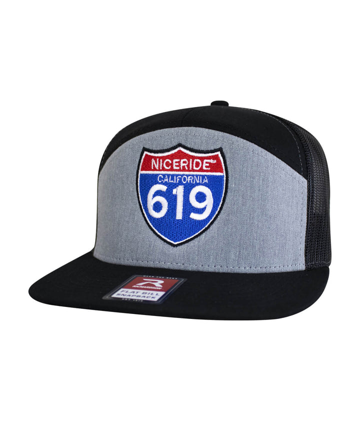 Interstate 619 7 Panel Trucker Snapback Hat For Men And Women with embroidered design and black mesh back.