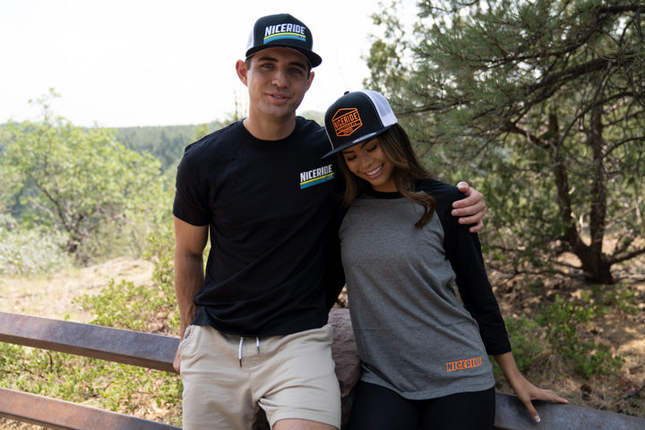 A man and woman wearing NICERIDE hats and casual clothing, enjoying the outdoors while showcasing the hat.