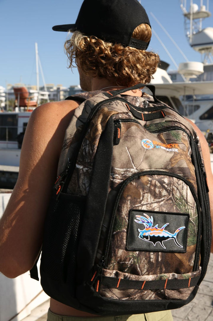 Buck-Eye Explorer camo backpack with embroidered patch and Realtree Xtra design, ideal for outdoor adventures.